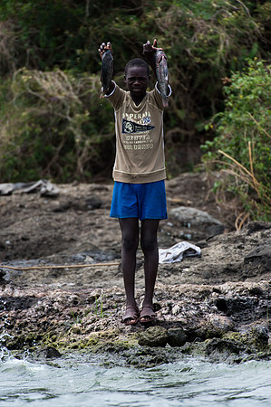 Proud boy shows off his catch - Mfangano Island, Kenya