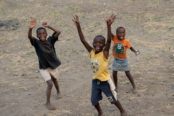 Kids waving at the train in Livingstone, Zambia